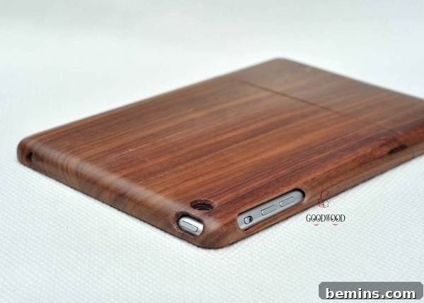 A wood case covering a tablet has cutouts for the buttons. Walnut iPad Case from Good Wooden.