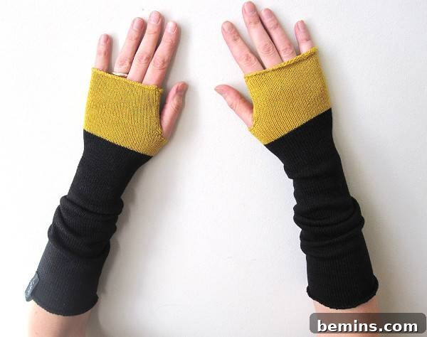 Two hands with knitted wraps. Handmade fingerless gloves from Laine's.