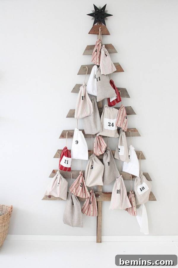 A Christmas tree on the wall is made out of many materials.