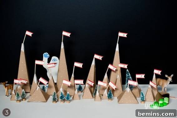 Pyramid cardboard building with flags with yeti climbing mountain and pine trees.