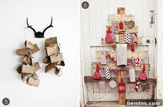 A pair of dark antlers hanging on the wall with brown packages hanging from each antler and a white rustic wooden slat door with wrapped packages hanging from horizontal boards in front of it.