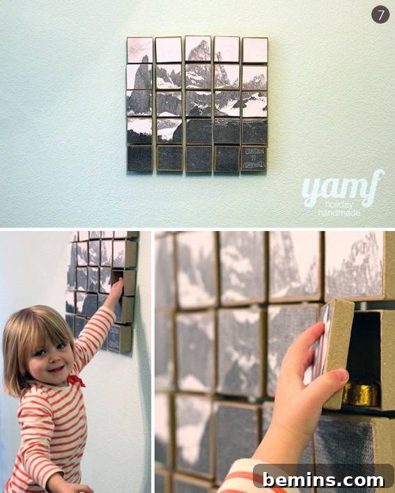 63 Creative DIY Advent Calendars to Spark Holiday Joy 35 A separated pieces barn scene wall art piece with a snowy mountain in the background, a little girl in a red and white striped shirt touching the wall art and a little girls hand grasping one of the wall art blocks.