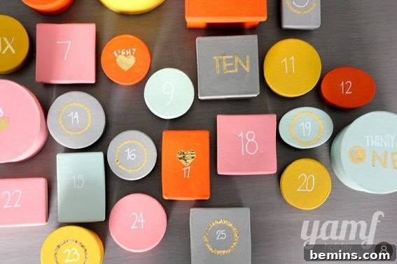 Orange, grey, yellow, pink, and teal blocks and circles have numbers on them to create an advent calendar.