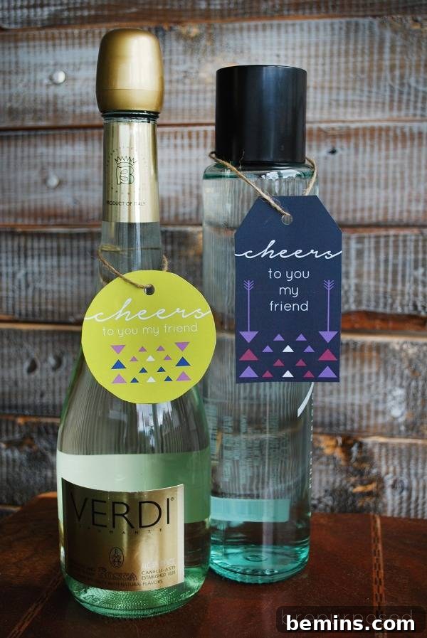 Wine is next to a tall bottle on a wooden table, tagged with free printable Christmas gift tags.