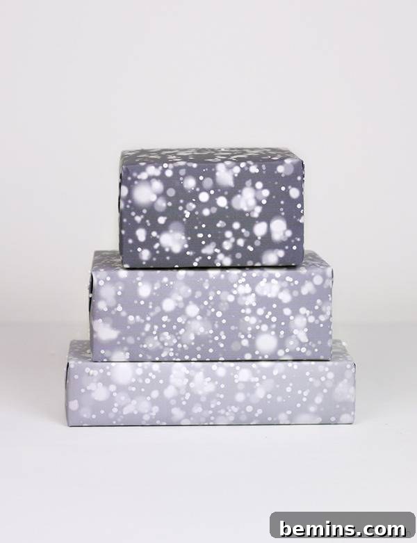 Three boxes wrapped in falling snow-themed wrapping paper.
