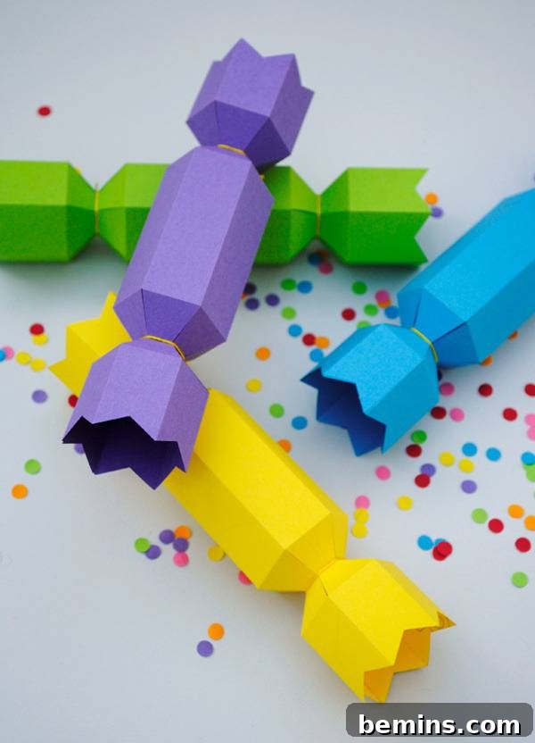 Colorful tubes sit on a white surface with confetti.