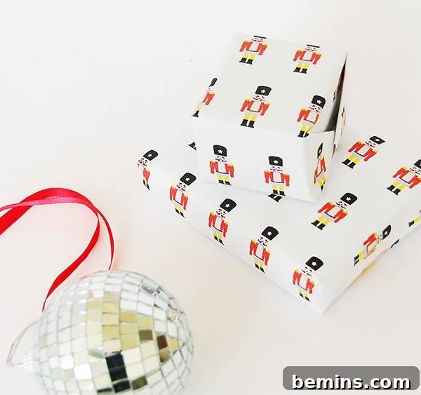 Gifts wrapped in Nutcracker-themed wrapping paper with a disco ball ornament nearby.