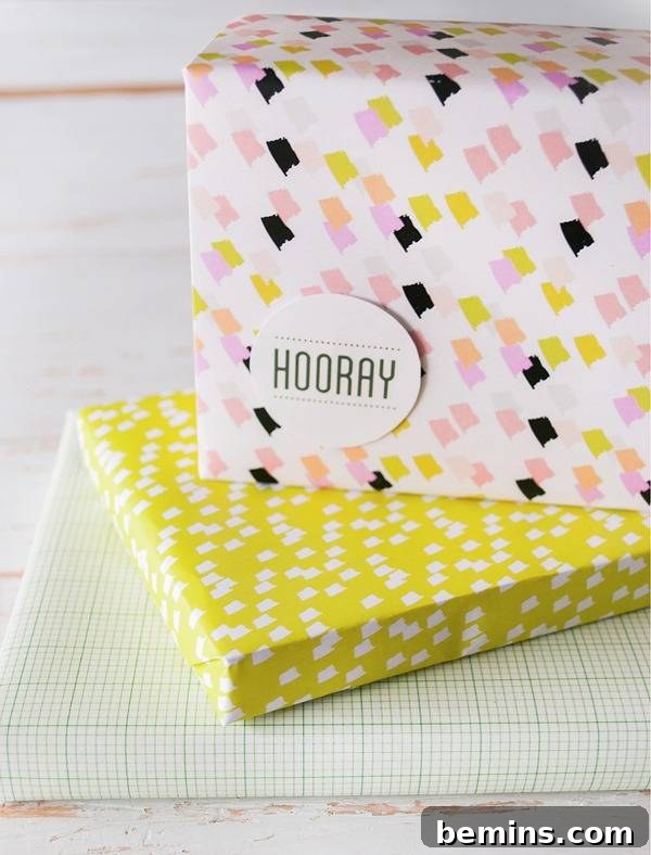 Yellow and pink wrapped presents on a white cloth.