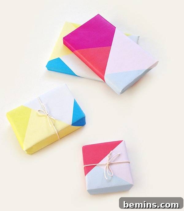 Colorful presents wrapped in geometric colorblock wrapping paper on a white background.