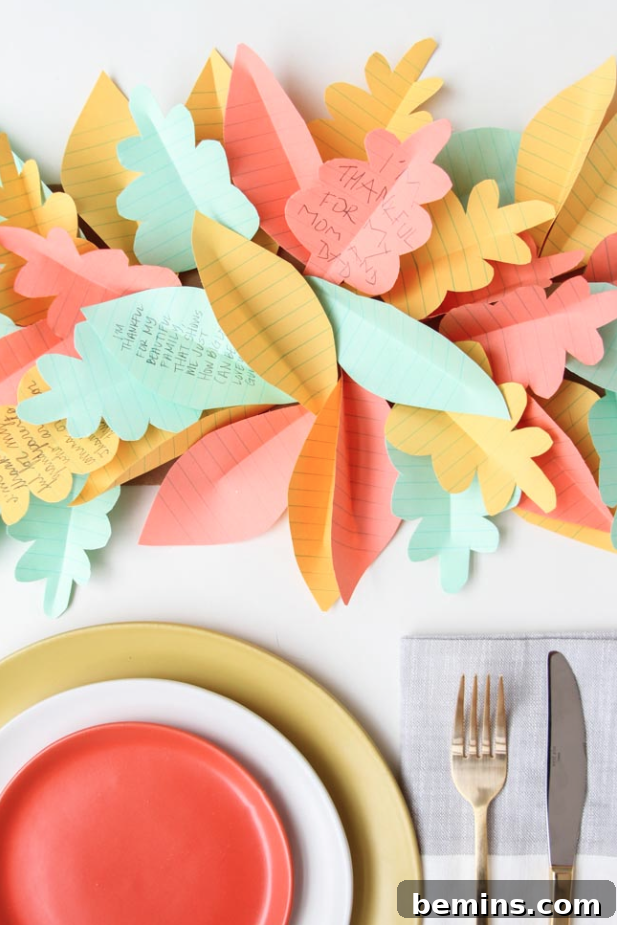 Quick & Easy Thanksgiving Table: 13 DIY Ideas Under an Hour 4 Pastel colored table with paper leaf Thanksgiving table runner.