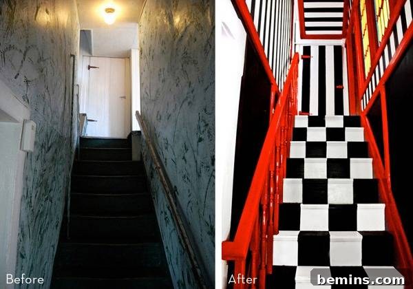 A Black and White Stairs with Red Rails.
