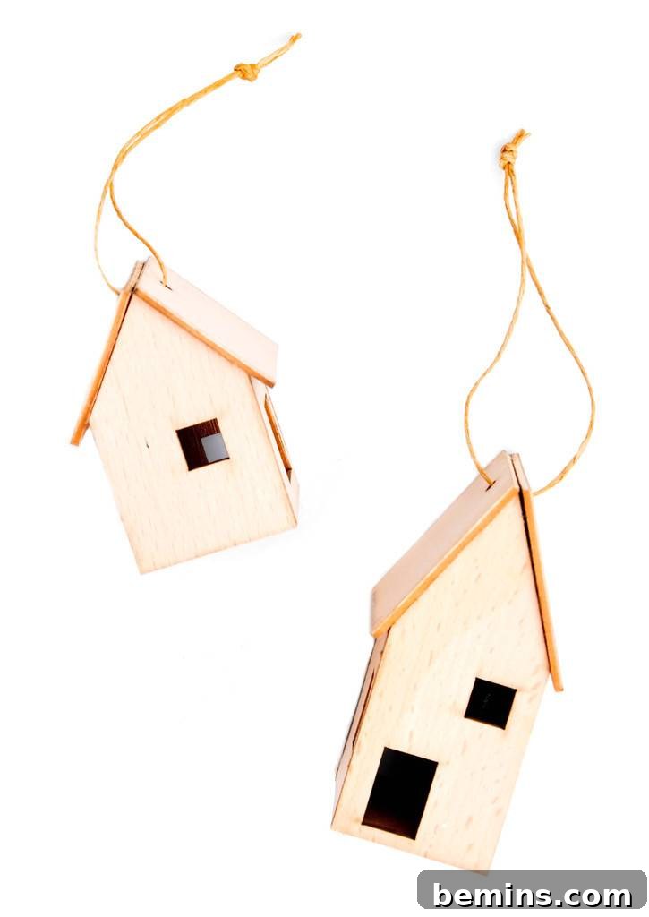 The Ultimate Ornament Roundup: 12 Must-Have Decorations for Your Tree 11 Two model houses are hanging from strings.