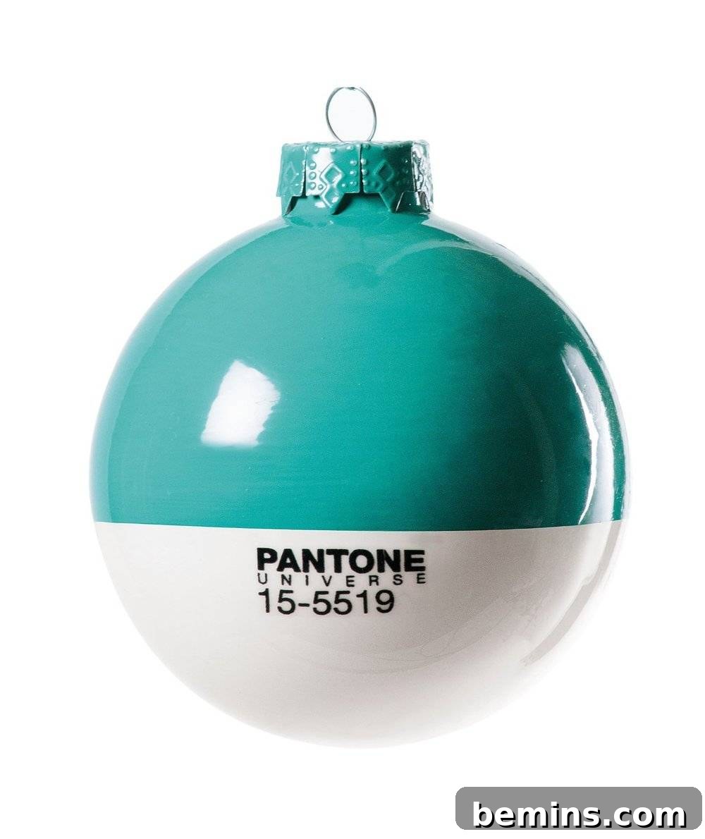 The Ultimate Ornament Roundup: 12 Must-Have Decorations for Your Tree 6 A white and green Pantone Christmas ornament.