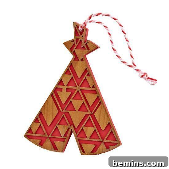 The Ultimate Ornament Roundup: 12 Must-Have Decorations for Your Tree 9 An ornament with red and wood shaped designs.