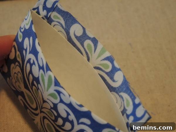 A Gift envelop made of no sew fabric, demonstrating the final gluing and folding stage.