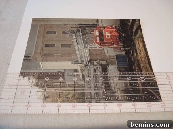 A photo of a construction site sits on a white surface, used as a template for creating a larger fabric envelope.