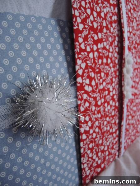 Tulle and a sparkly pom pom and few fabric gift envelopes, showcasing a variety of embellishments on the fabric envelopes.
