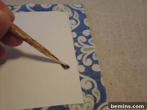 A person is about to draw something on the gift envelope, illustrating the glue application process.