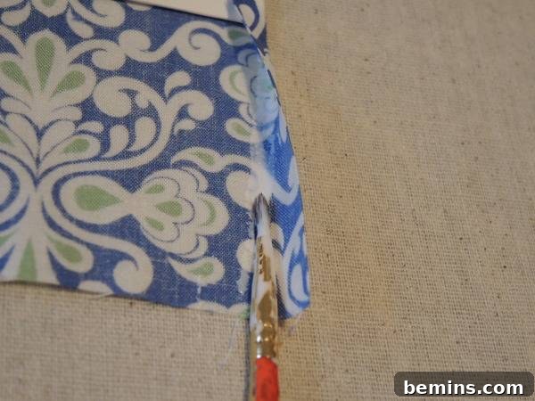 Backside of the fabric is glued with painting brush, illustrating the glue application on the side edges.