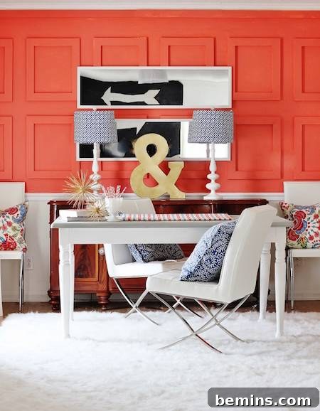 A desk with an & sign sits near a melon colored wall.