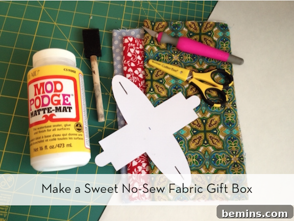 Cutting paper, glue, scissor, knife, fabrics are aside.