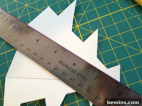 J. A. Moser creating the fold lines from the top to the bottom points.