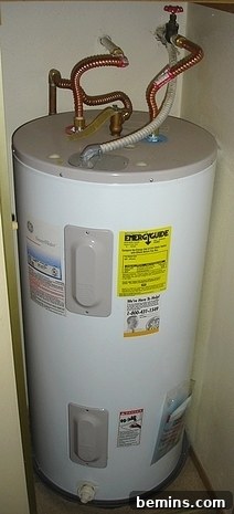 When the Hot Water Runs Cold: DIY Removal of Your Old Electric Water Heater 2 Round white water heater with brass pipes sprouting from the top.