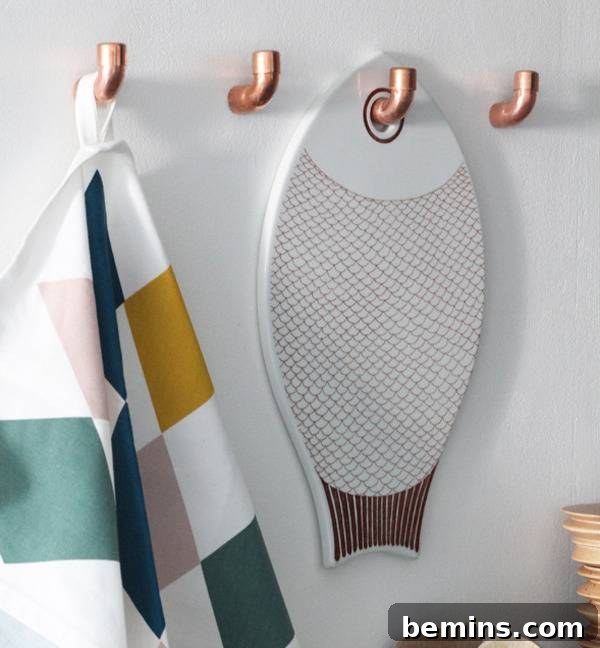 Metal hooks on the white wall hold objects.