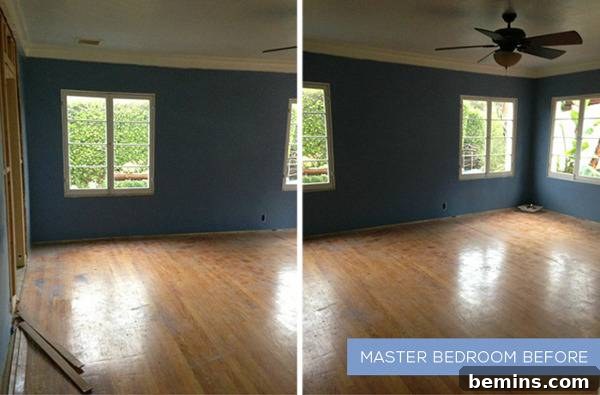 Before: A bedroom with blue walls, wood flooring, unshaded windows, and a ceiling fan - awaiting a modern transformation