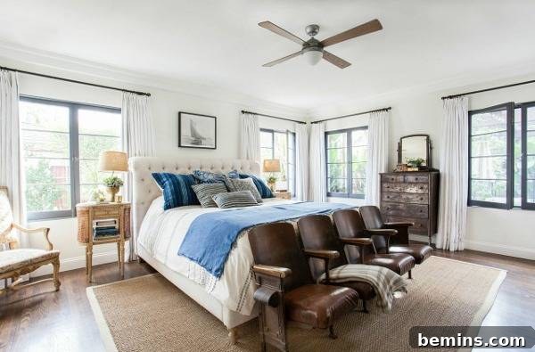 After: A master bedroom blending old-world charm with modern elements, featuring leather chairs and a sophisticated design