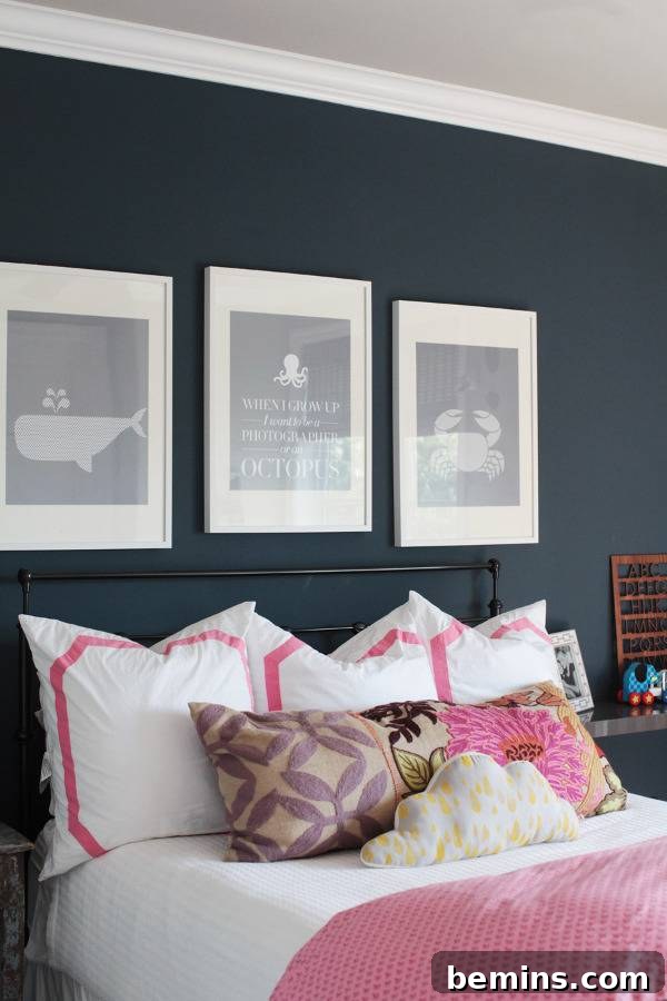 Pink Power: 16 Dreamy Bedrooms for the Bold at Heart 17 Pink color bed and wall painting frames on black wall.