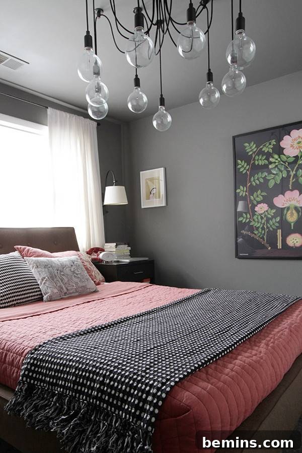 Pink Power: 16 Dreamy Bedrooms for the Bold at Heart 6 A window is letting in light above a bed set beneath a chandelier.