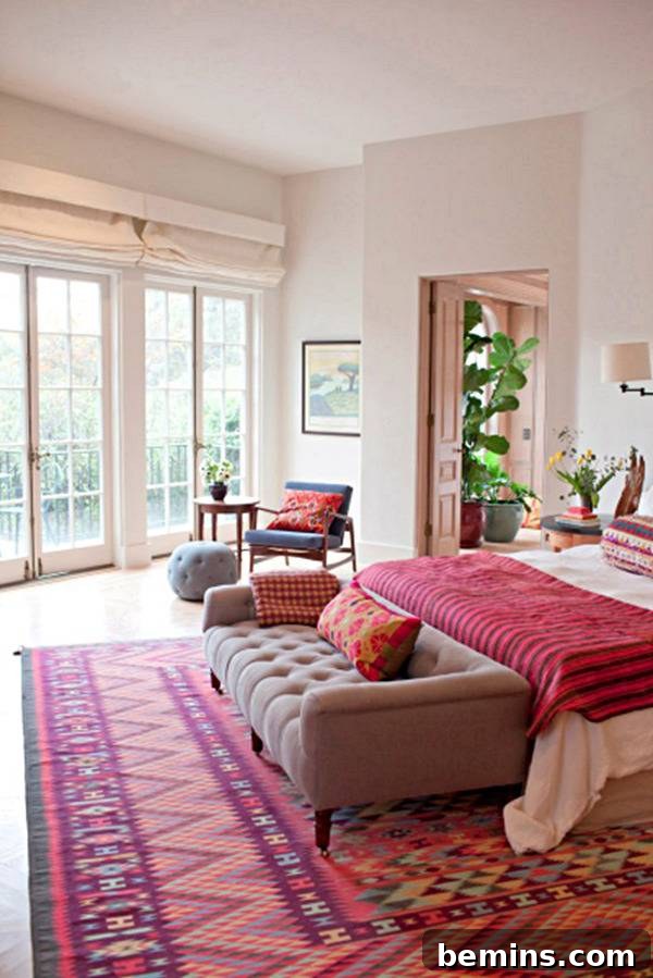 Pink Power: 16 Dreamy Bedrooms for the Bold at Heart 9 Pink bedroom with bed, couch, potted plants, table and chair.