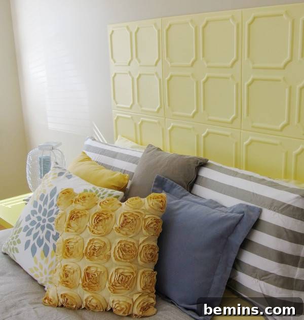Unique DIY Headboard Designs to Reinvent Your Bedroom 12 Several pillows are stacked on a bed near a yellow headboard.