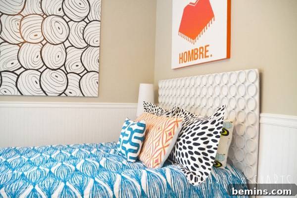 Unique DIY Headboard Designs to Reinvent Your Bedroom 19 Bed with head board with circles with lots of pillows and two pictures on wall.