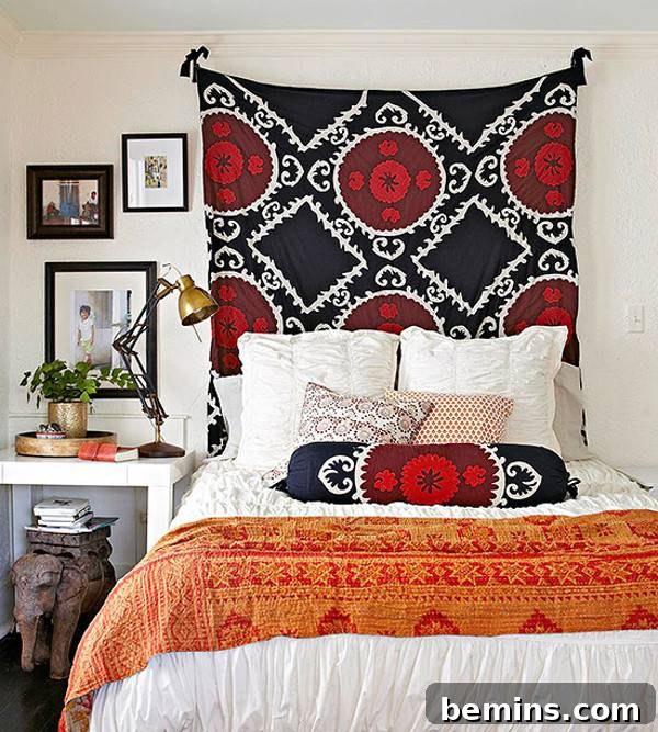 Unique DIY Headboard Designs to Reinvent Your Bedroom 22 A red and black throw hangs on the wall behind a bed.