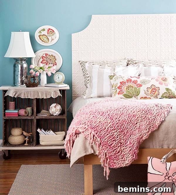 Unique DIY Headboard Designs to Reinvent Your Bedroom 24 A bed with a pink towel and grey and white striped pillows on it sits next to a nightstand.