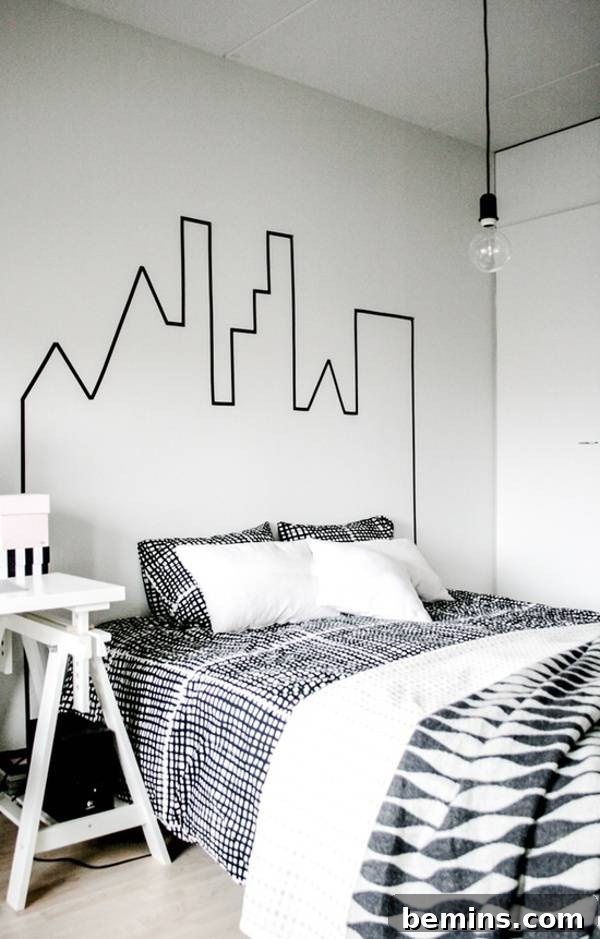 Unique DIY Headboard Designs to Reinvent Your Bedroom 4 A black and white bedroom with a bed in black and white sheets and cover with a single pendulant light hanging over the bed.