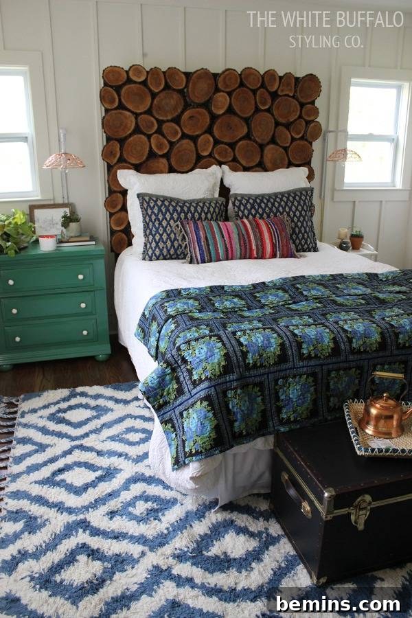 Unique DIY Headboard Designs to Reinvent Your Bedroom 10 A bed with a headboard that looks like a stack of logs.