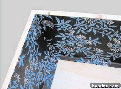 Close-up of decorative paper being measured and cut for the wine crate display