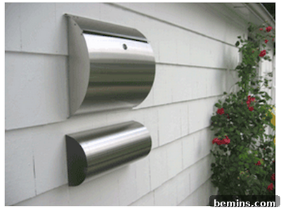 Modern stainless steel wall-mounted mailbox with a newspaper holder.