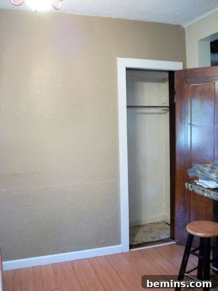 The corner of a dining room with an underutilized coat closet opened up and expanded, showing its readiness for conversion into an office space.