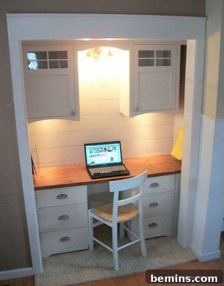A white working desk with a laptop and a matching white chair, showcasing a refined home office created within a converted dining room closet.