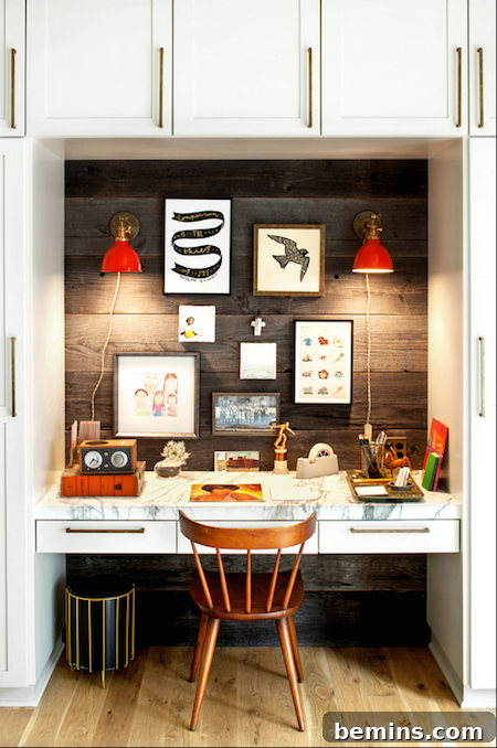 A wooden chair at a desk, surrounded by white cabinets, with a delightful pop of color, creating a vibrant and characterful alcove office space.