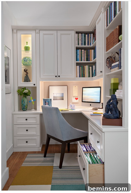 Small home office space with a grey chair facing a computer monitor that is beneath bookshelves, demonstrating excellent vertical storage.
