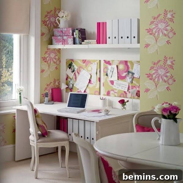 A small alcove off a dining area efficiently utilized as an office space, featuring a white desk, decorative wall paper, and a comfortable chair, blending seamlessly with its surroundings.