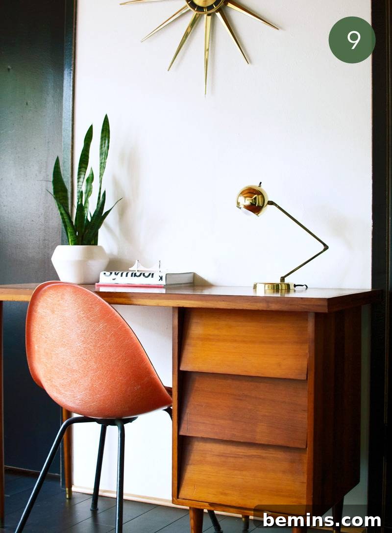 A mid-century modern workspace with rounded shapes and brass accessories