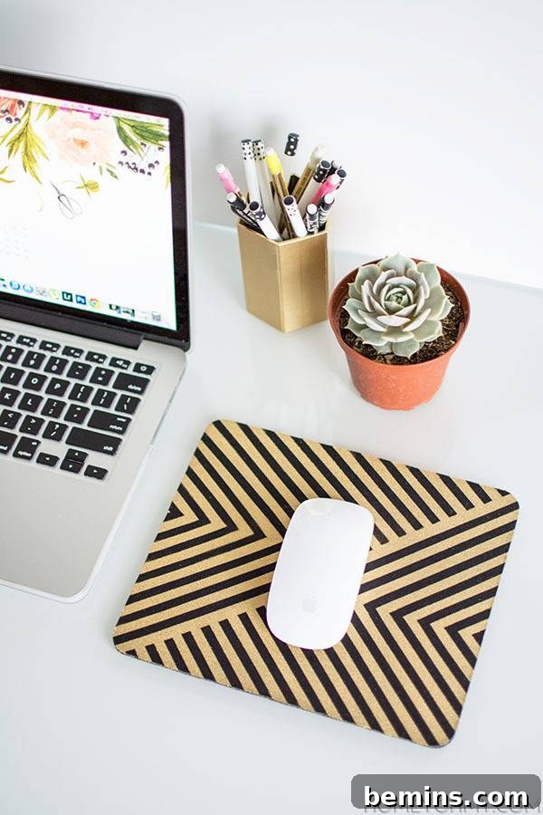 A laptop is sitting on the table near pens and a mousetop.