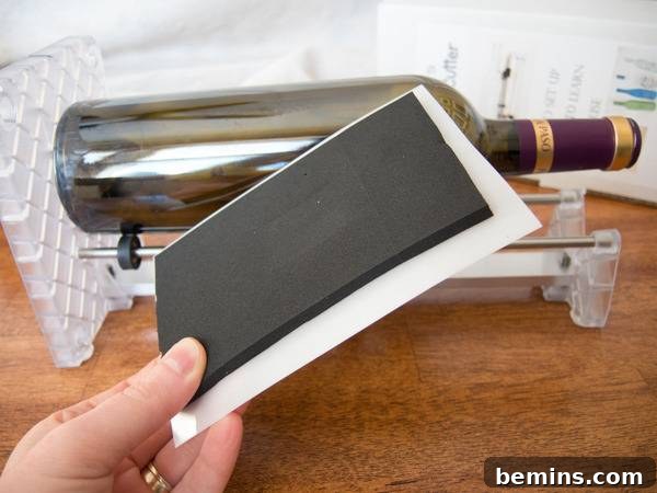 Which Bottle Cutter Reigns Supreme? A Definitive Review 37 A hand holding a piece of paper and a glass bottle is lying near it.
