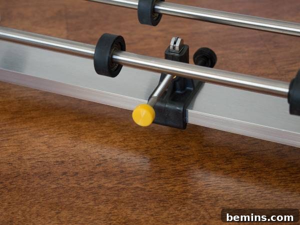 Which Bottle Cutter Reigns Supreme? A Definitive Review 38 Black clamp with yellow knob on a metal bar.